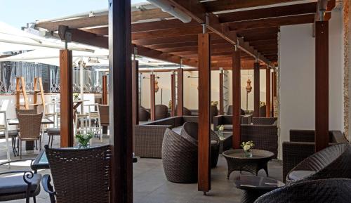 a restaurant with tables and chairs on a patio at Hyatt Regency Cape Town in Cape Town
