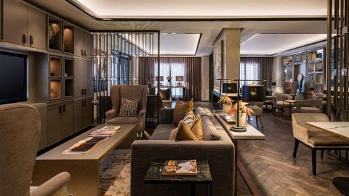 a living room with a couch and a tv at Hyatt Regency Cape Town in Cape Town
