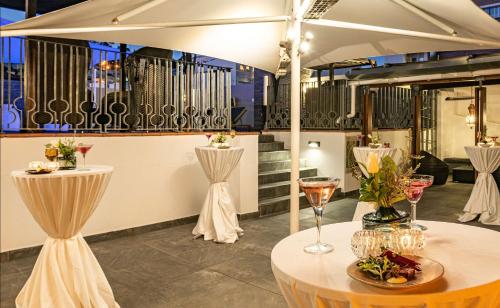 a restaurant with two tables with glasses of wine at Hyatt Regency Cape Town in Cape Town