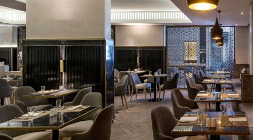 a dining room with tables and chairs and tablesktop at Hyatt Regency Cape Town in Cape Town