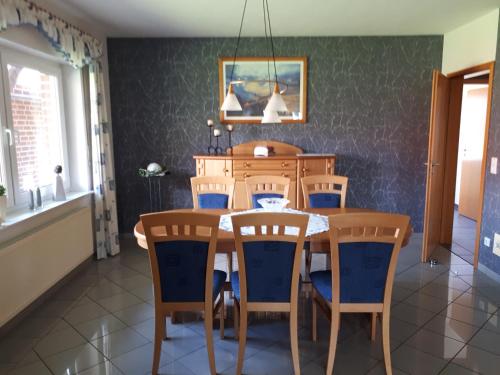 a dining room with a table and chairs at Haus konni in Haren