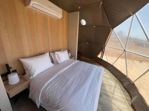 a bedroom with a large bed in a tent at Mysk Moon Retreat in Sharjah