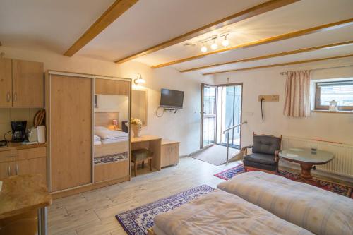 a large room with a bed and a desk and a table at W Ciemno in Ciemno
