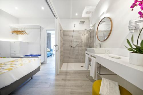 a white bathroom with a sink and a shower at Relaxia Los Girasoles Bungalows in Playa del Ingles