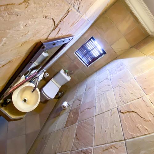 a bathroom with a toilet and a sink at Spacube Luxury Suites and Spa in Pretoria