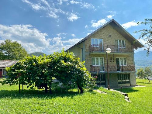 a house with trees in front of it at Vila Vidak in Mojkovac