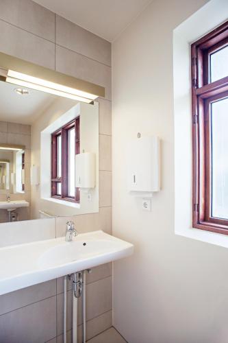 a bathroom with a sink and a mirror at Student Hostel in Reykjavík