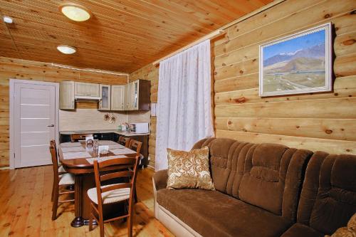 a living room with a couch and a table in a cabin at Tourist complex Gornoe Ozero in Artybash