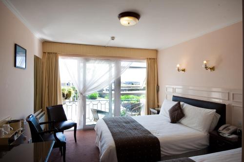 Postel nebo postele na pokoji v ubytování Pontac House Hotel