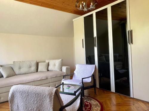 a living room with a couch and a chair at Vila Vidak in Mojkovac