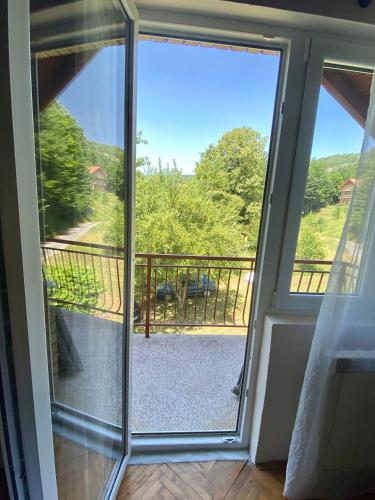 a sliding glass door with a view of a balcony at Vila Vidak in Mojkovac