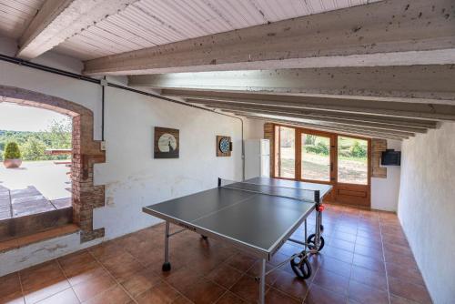 a ping pong table in the middle of a room at Casa Rural Moixella in Lladurs