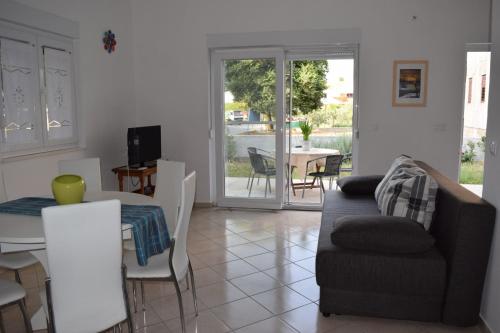 a living room with a couch and a table at Apartman Julka in Sukošan
