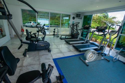 a gym with several exercise equipment in a room at Favorita Golden Hotel e Eventos in São José
