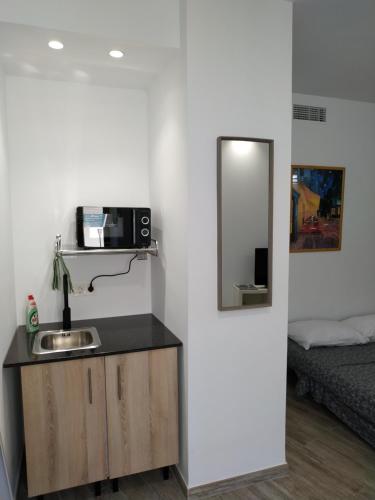 un bagno con lavandino, specchio e letto di Altozano Room I, Estudió, centro de Málaga, GayFriendly, Wi-Fi gratis a Málaga