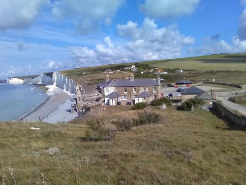 a house on a hill next to the ocean at The Iverna in Eastbourne