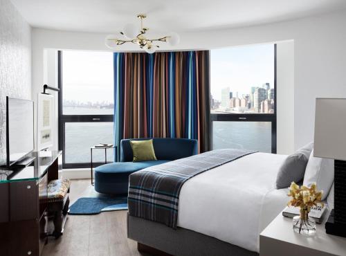 a bedroom with a large bed and a blue chair at Graduate by Hilton New York in New York