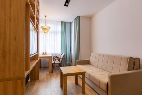 a living room with a couch and a table at Apartmoon in Sarajevo