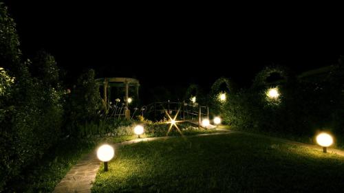 a garden at night with lights in the grass at Il Mondo B&B in Fiumicino