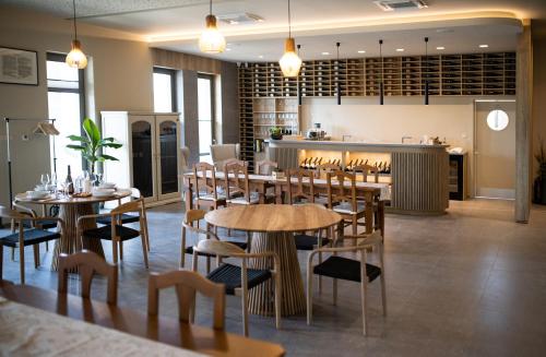 a restaurant with tables and chairs and a kitchen at Kasnyik winery in Strekov