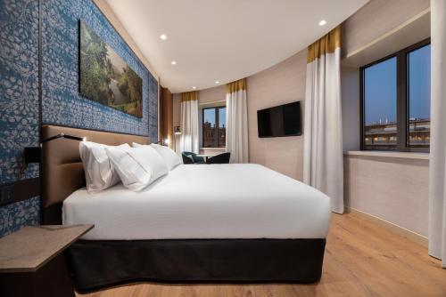 a hotel room with a large bed and a large window at Eurostars Aliados in Porto