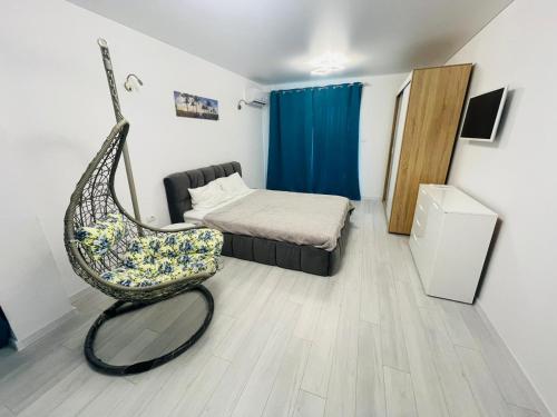 a room with a bed and a chair in it at Vila LaDom Etajul 1 in Mamaia Sat/Năvodari