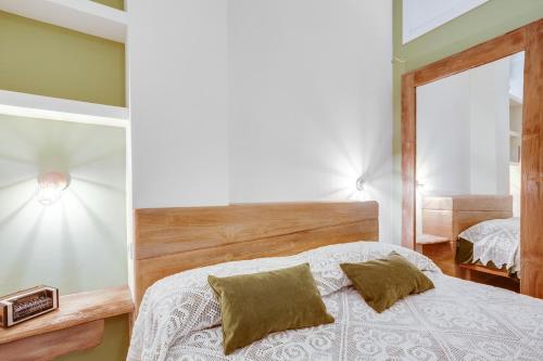 a bedroom with a bed and a mirror at MADAME BARI' Suite Apt in the heart of Bari in Bari