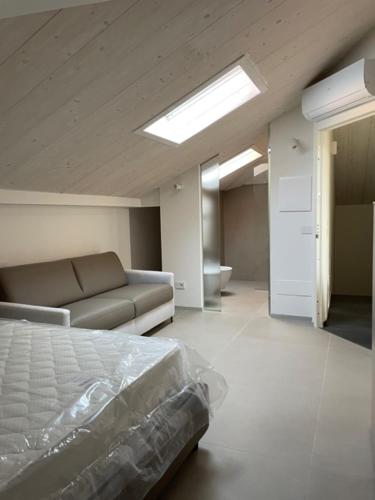 a bedroom with a bed and a couch in it at Domus Mazzini in Cattolica