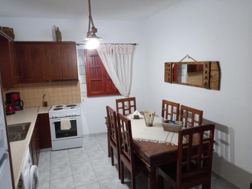 a kitchen with a table and chairs and a stove at Pyrgos in Limbókhova