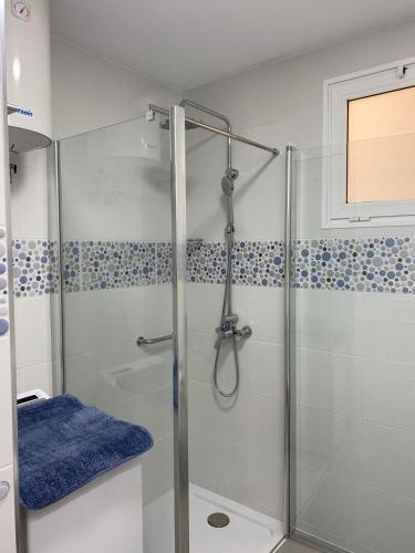 a shower with a glass door in a bathroom at Holamigos Morro Jable in Morro del Jable