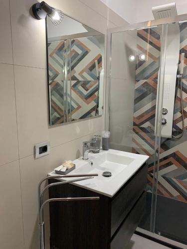 a bathroom with a sink and a mirror at Albergo Piazza Risorgimento in Porto Cesareo