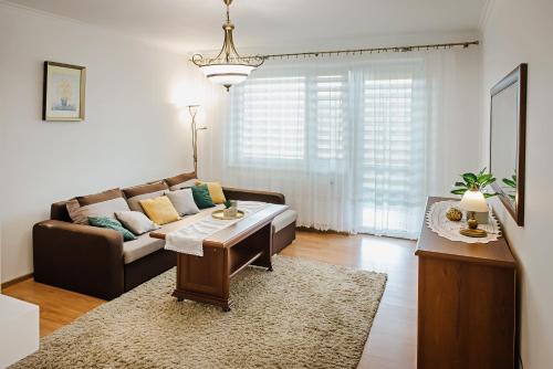 a living room with a couch and a table at Apartament Witkiewicza Sanok in Sanok