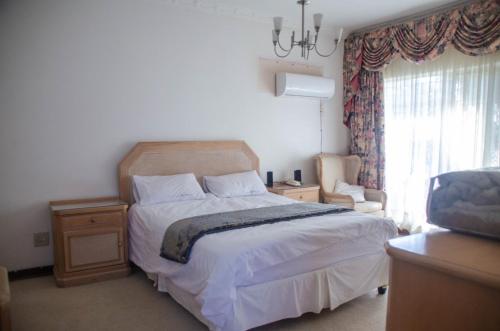 Postel nebo postele na pokoji v ubytování Simunye Guest House