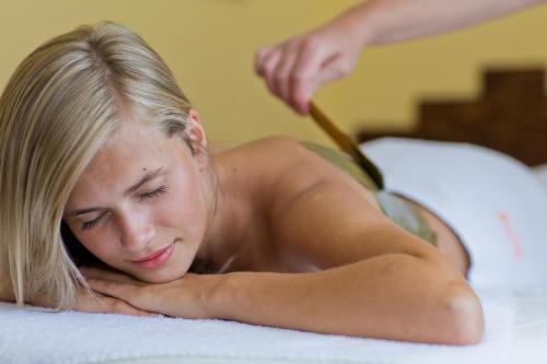 a young woman laying on a bed with at Hotel REDYK Ski&Relax in Zakopane