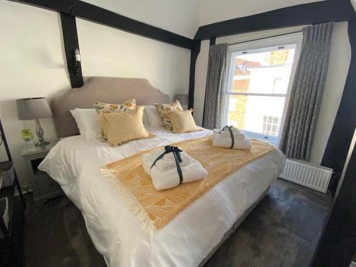 a bedroom with a bed with two bags on it at Purlins Holiday Apartment in Salisbury