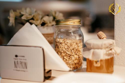 a jar of granola and a container of honey at VenuSuite VENOSA - Luxury House, Spa & Relax - in Venosa