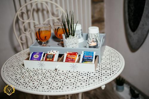 a white table with a shelf with products on it at VenuSuite VENOSA - Luxury House, Spa & Relax - in Venosa