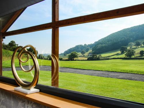 a window with a view of a green field at Meadow View in Meifod