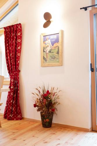 a room with a picture on the wall and a plant at Chalet del Capriolo in Vodo Cadore