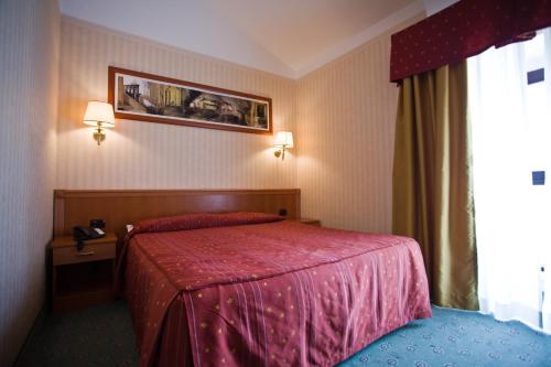 Postel nebo postele na pokoji v ubytování Palace Hotel San Michele