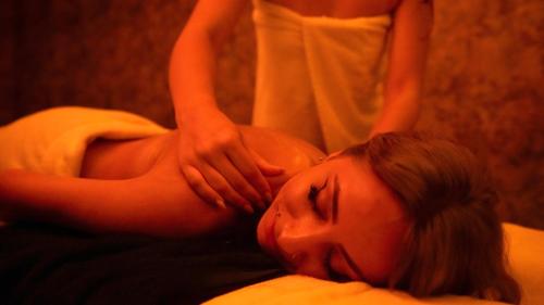 a woman laying on a bed receiving a massage at Orient Express & Spa by Orka Hotels in Istanbul