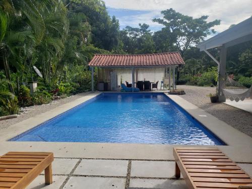 a swimming pool with a gazebo in a backyard at Casa Vistas del Rio in Sámara