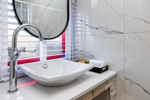 a bathroom with a white sink and a mirror at Pamper yourself in our DOUBLE SIZED copper tub -2 bedroom villa in Inverness