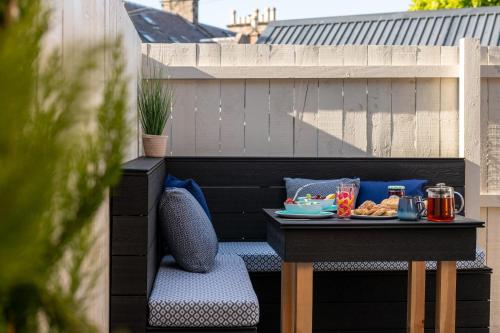 a table with a tray of food on a patio at Pamper yourself in our DOUBLE SIZED copper tub -2 bedroom villa in Inverness