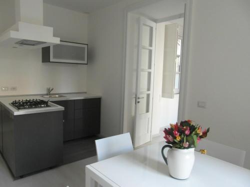 a kitchen with a table with a vase of flowers on it at Casa Umberto I in Catania