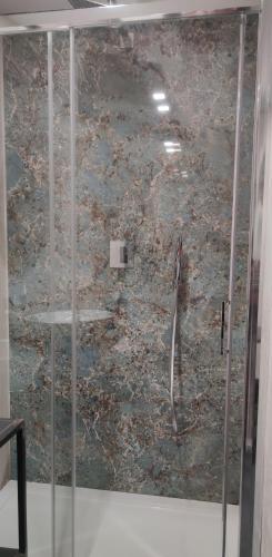 a shower with a glass door in a room at Panoramica dei Templi B&B in Agrigento