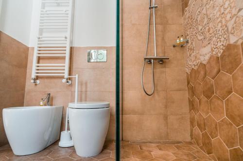 a bathroom with a toilet and a shower at La Casa di Ele in Matera