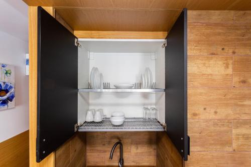 a kitchen with a black cabinet with a sink at Lighthouse Friendly Holiday Home in Playa del Ingles