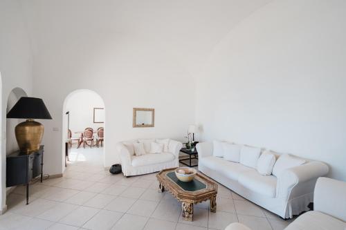 a living room with a white couch and a table at Villa Giusy in Positano