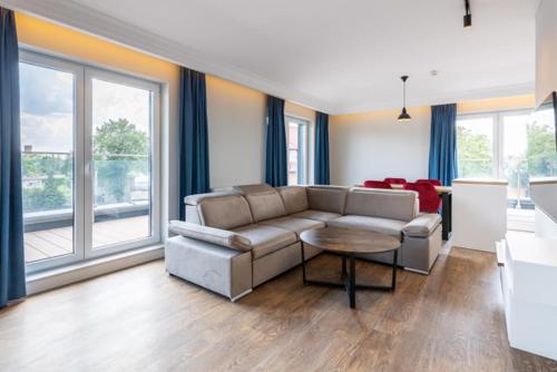 a living room with a couch and a table at Leeloo in Człuchów